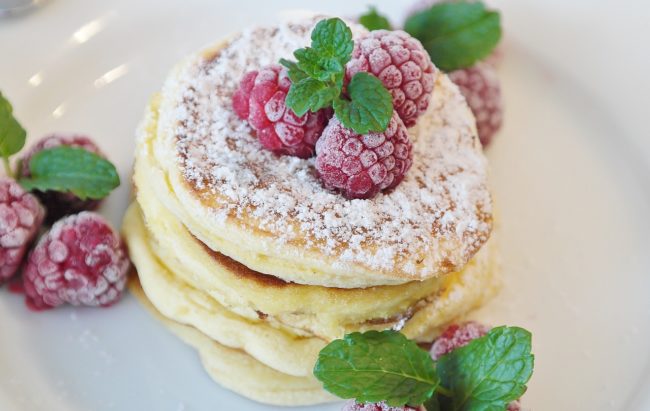 stack of pancakes with powdered sugar and raspberries - real estate blog seo example