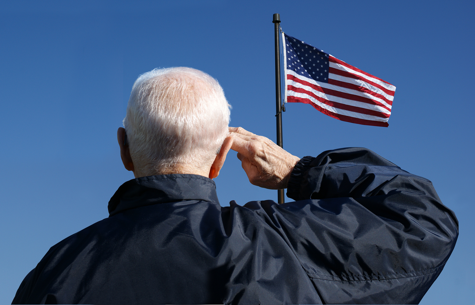 Veteran saluting the US flag