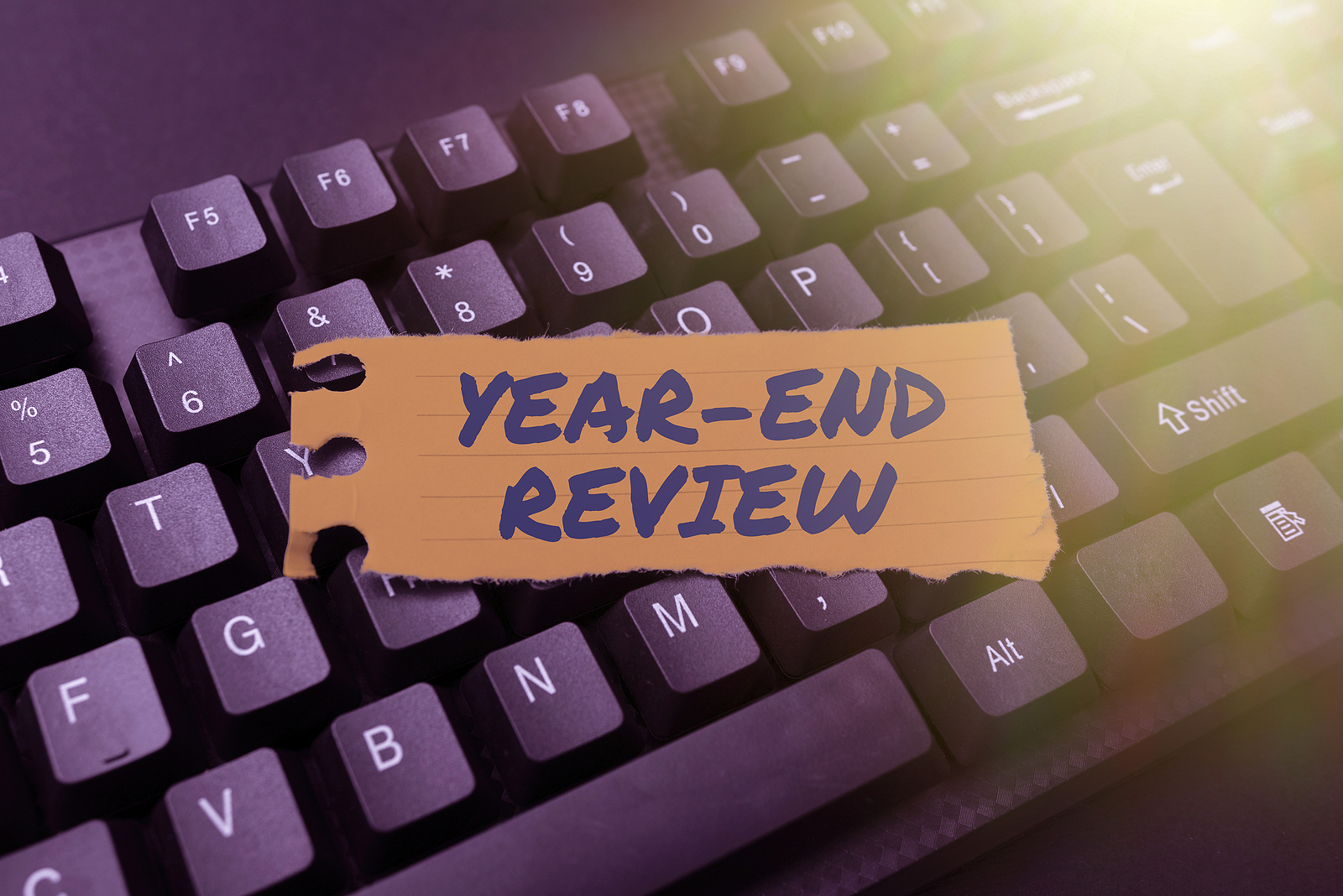 Year end review text over image of a keyboard