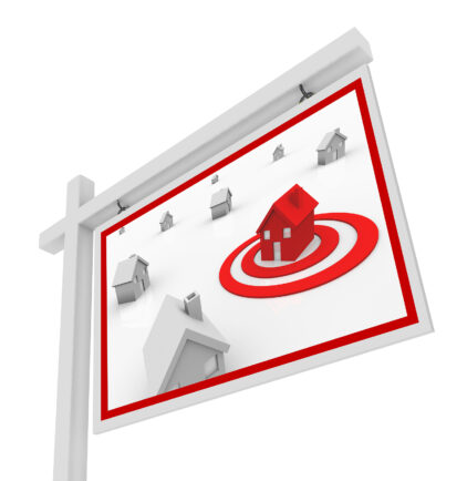 A house in a red target bulls-eye on a for sale sign symbolizing the search for the right real estate home for you in your upcoming move or relocation