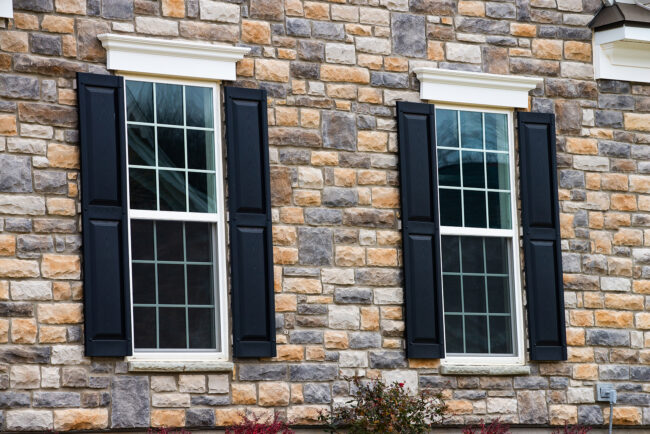 two pane vinyl window with shutters on a vinyl siding house siding for fall curb appeal.