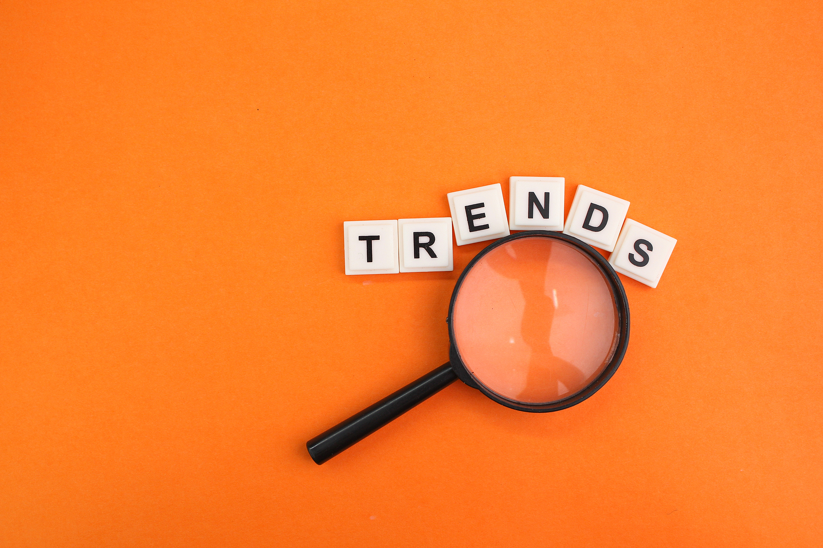 Magnifying Glass And Letters Of The Alphabet With The Word Trend