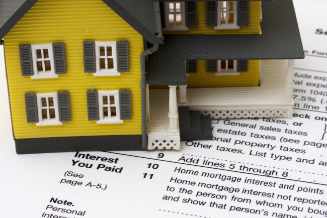 House with money and tax paper  us schedule A form