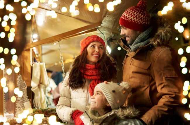 family, winter holidays and celebration concept. Family looking at homes with Christmas lights.